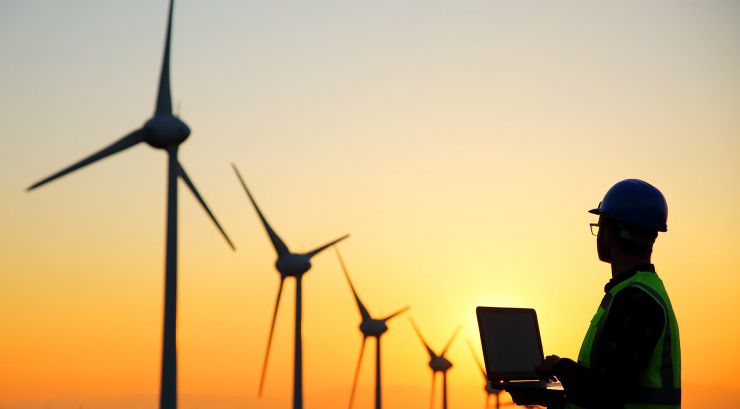 technician checking wind turbines