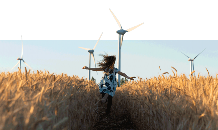 little girl running through field of windmills